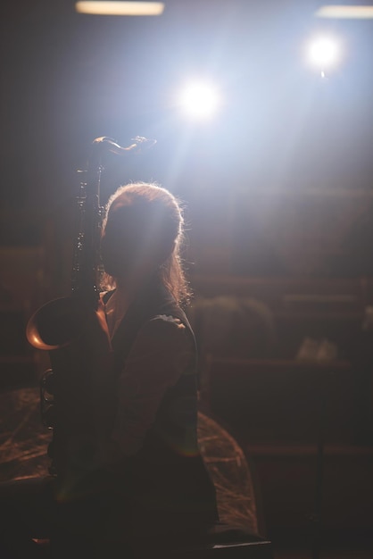 The girl playing the saxophone