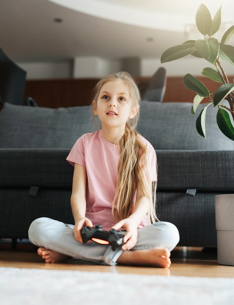 Girl playing video game at home