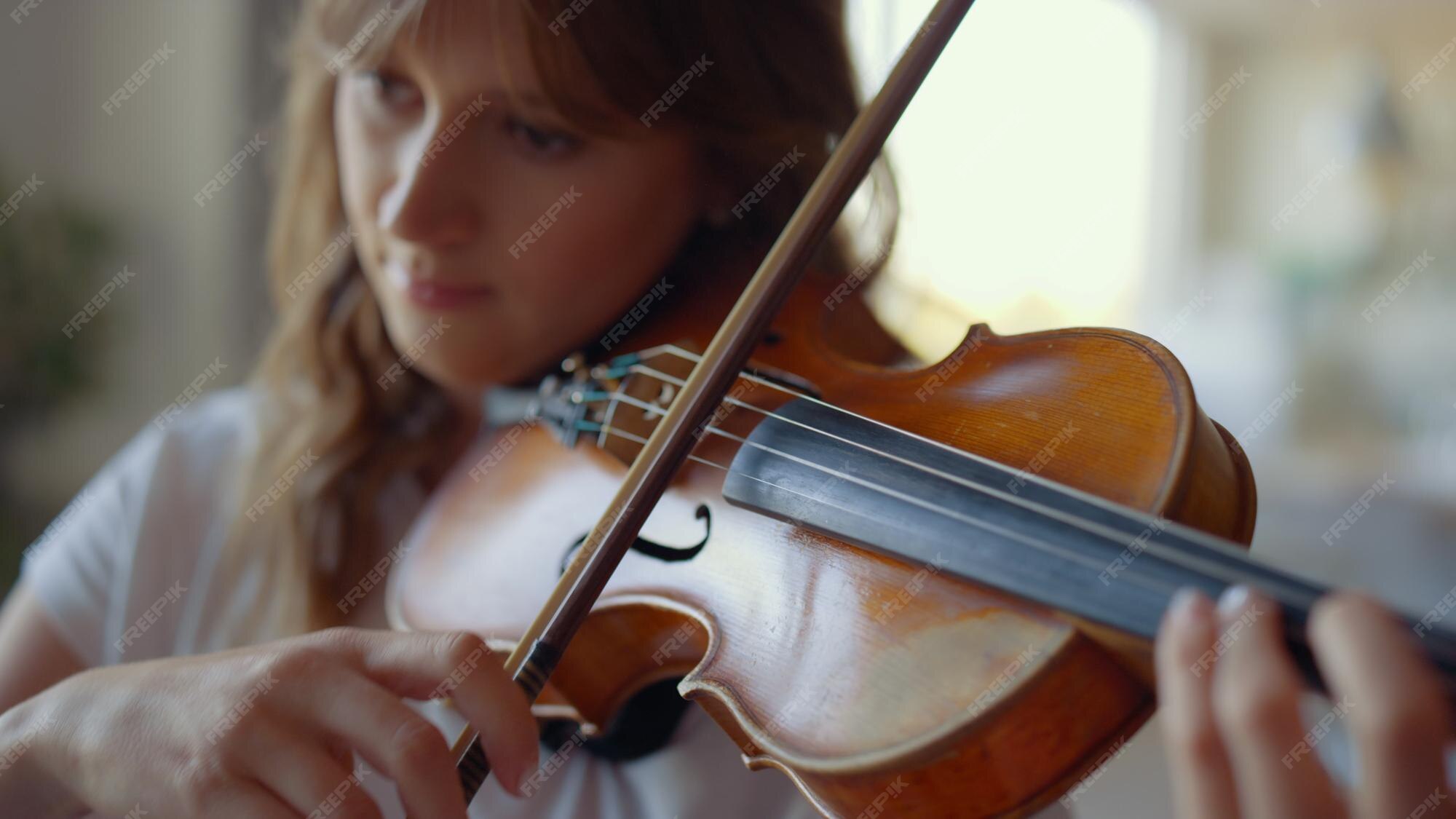 Premium Photo | Girl playing violin at home violinist playing chords on