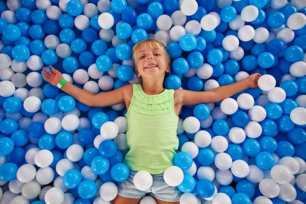 Girl playing with ball in playroom.