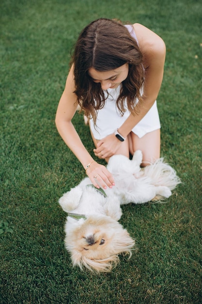 Girl playing with a dog on the lawn