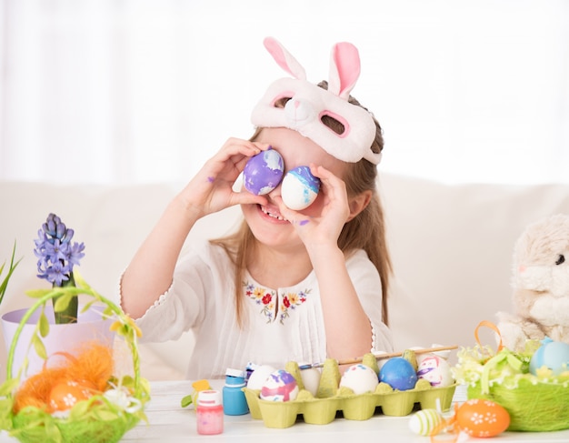 Girl playing with Easter eggs collection