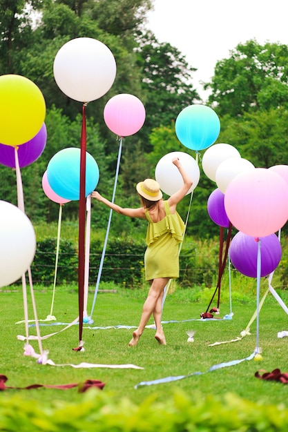 Girl playing with multicolor balloons