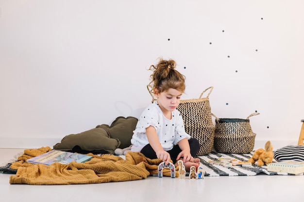 Girl playing with paper toys