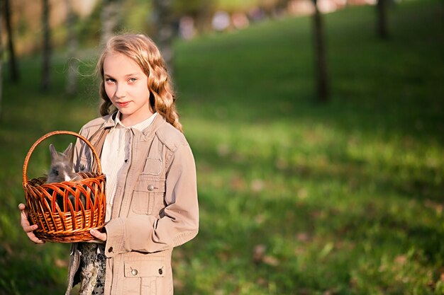 girl playing with rabbit in the park