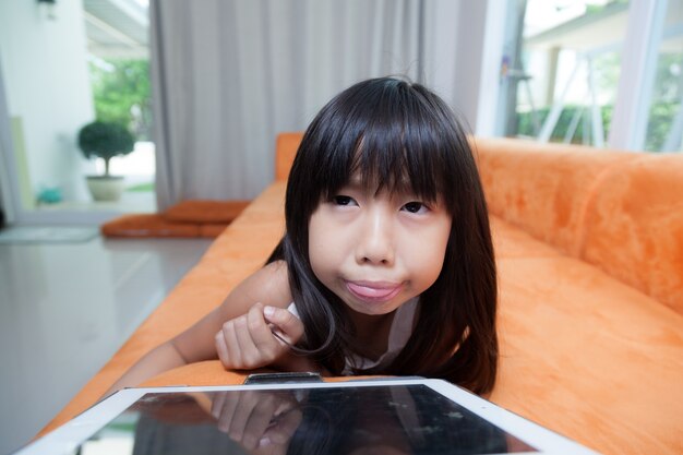 Girl playing with tablet.