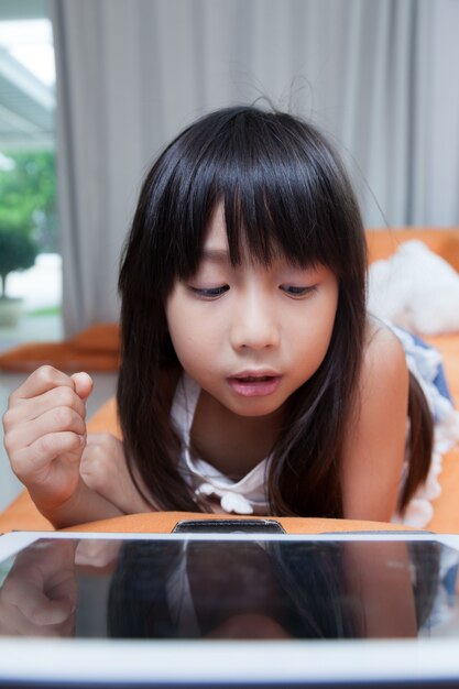 女の子、タブレットで遊ぶ。