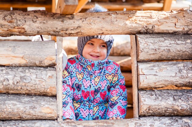 Girl playing in a wooden house