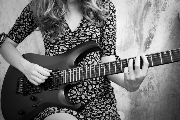 Photo girl plays the electric guitar.