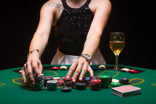 Girl plays poker and raises bets with chips