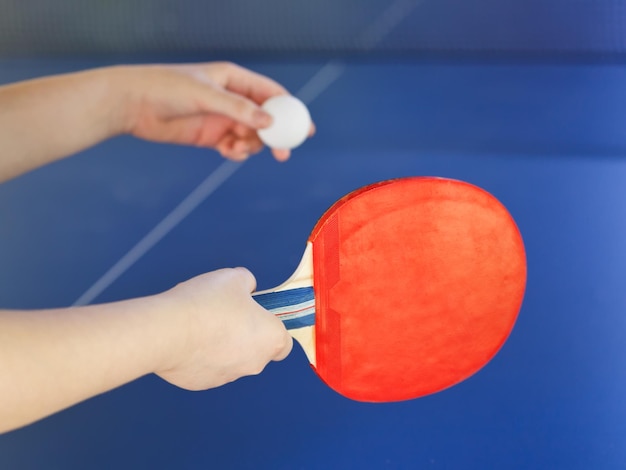 Girl plays in table tennis with red racket