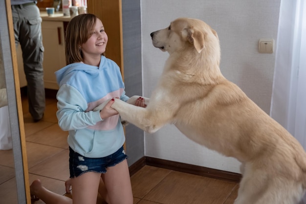 Girl plays with dog in room