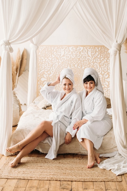 Girl plus size in robe and turban spa smile spa family day