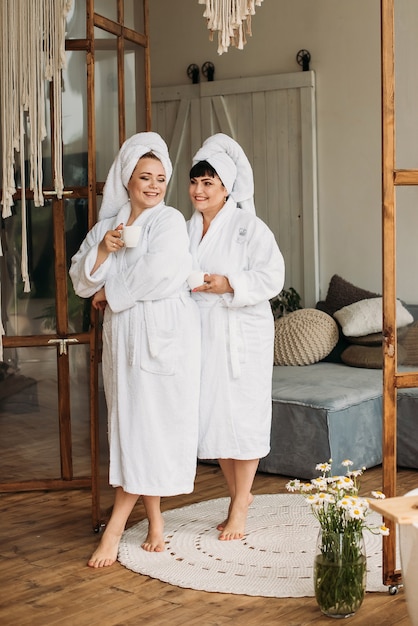 Girl plus size in robe and turban spa smile