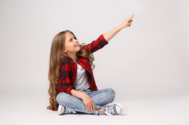 Girl pointing with her finger to copyspace