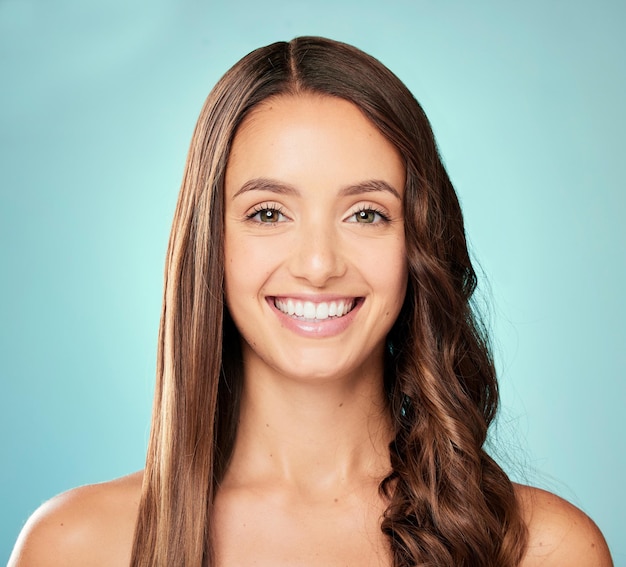 girl portrait and hair care in studio with smile healthy growth or glow on blue background for glamour straight style trendy model or face of woman with salon aesthetic beauty or keratin results