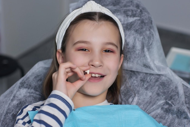 Girl portrait with a lost tooth Teenager child with a tooth dropped out