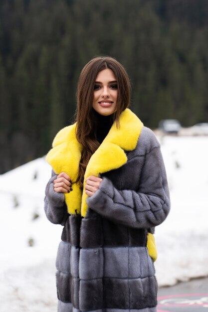 Girl posing on road on winter mountains