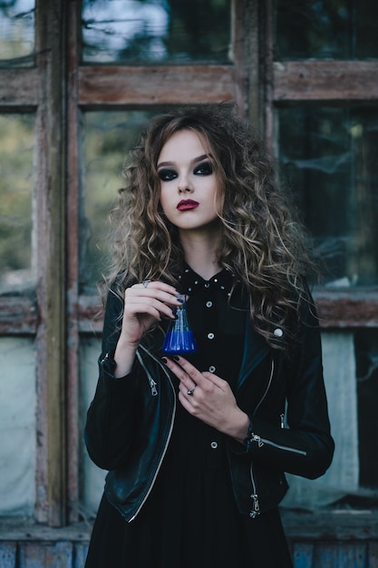 Girl posing in the street with black jacket and makeup