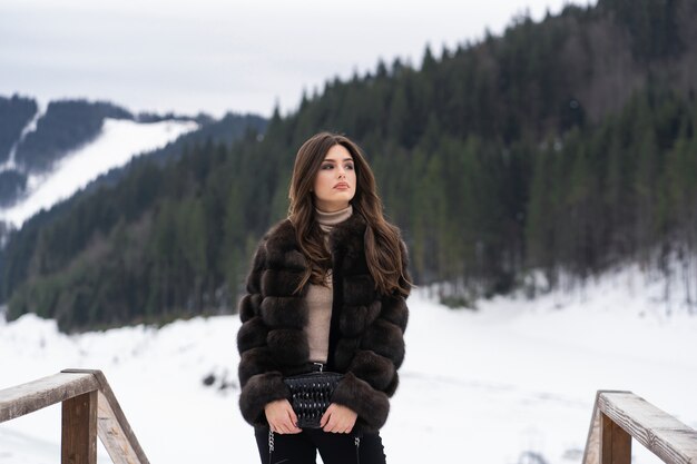 Girl posing on winter mountains