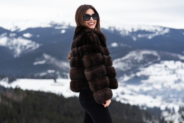 Girl posing on winter mountains