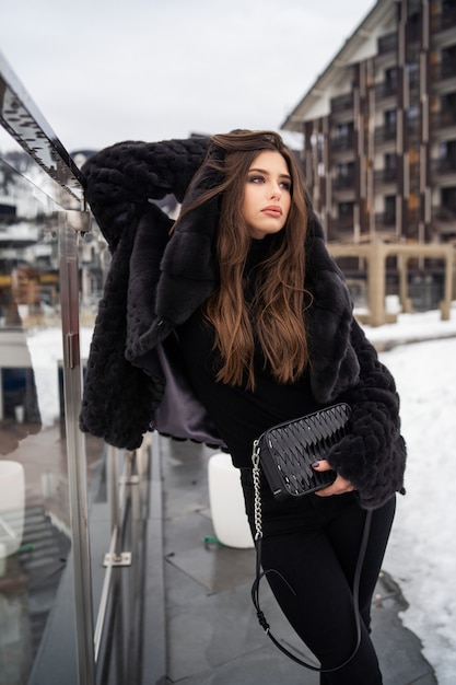 Girl posing on winter mountains 