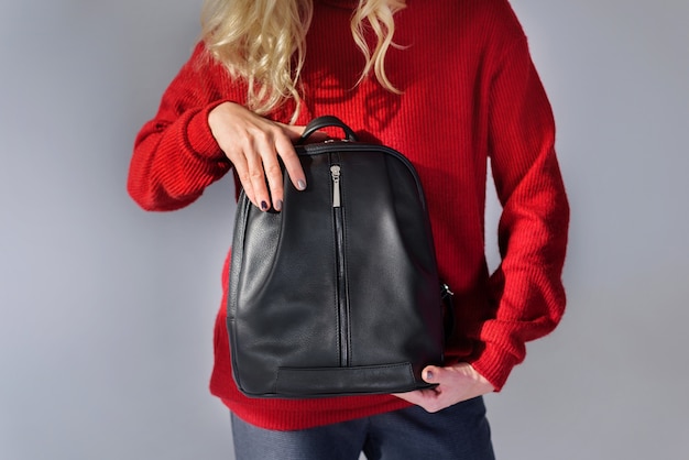 Girl posing with a backpack in the studio