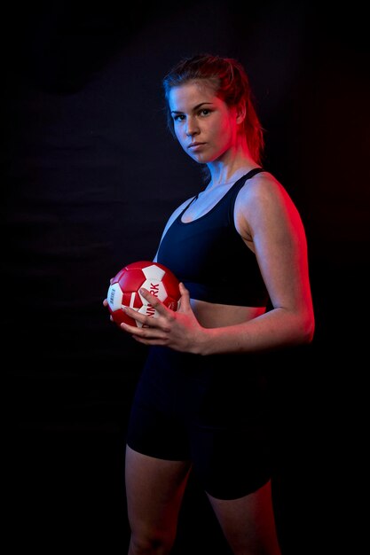 Girl posing with ball in hand