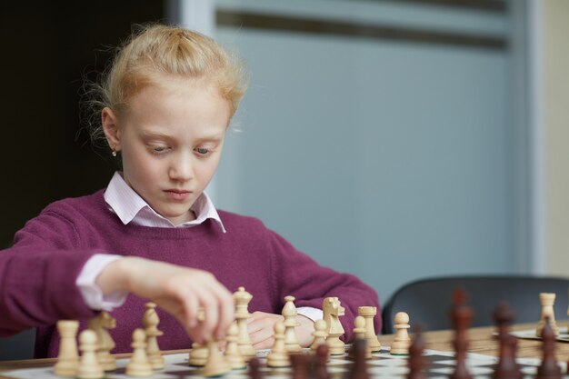 Girl practicing chess strategy