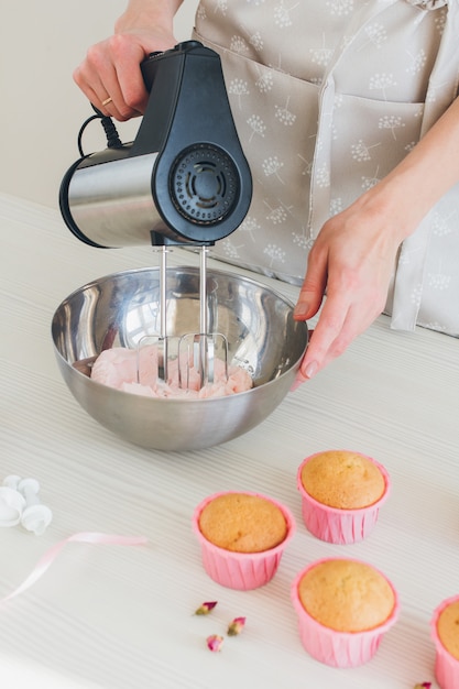 Girl prepares cupcakes