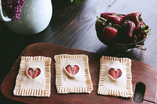 Girl preparing breakfast puff with strawberries