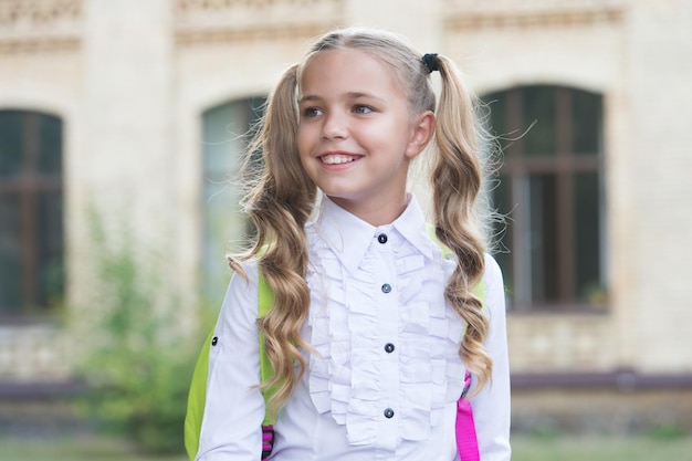 Girl primary school pupil happy going to school good mood concept