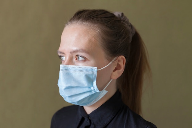 A girl in a protective mask from the coronavirus virus