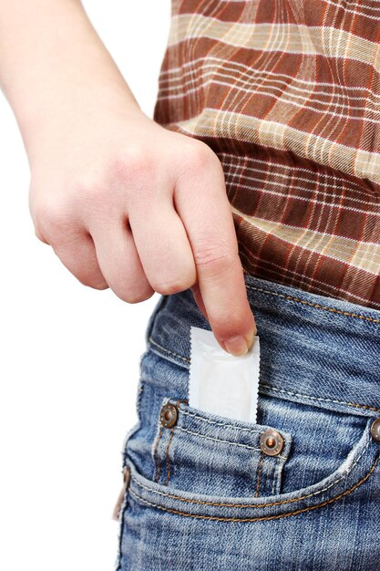 Girl pulling out condom from her jeans pocket close up