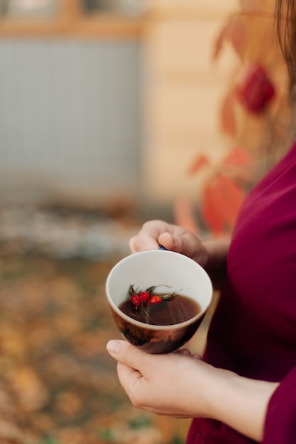 A girl in a purple dress holds a beautiful mug of tea in her hands and I have been for years