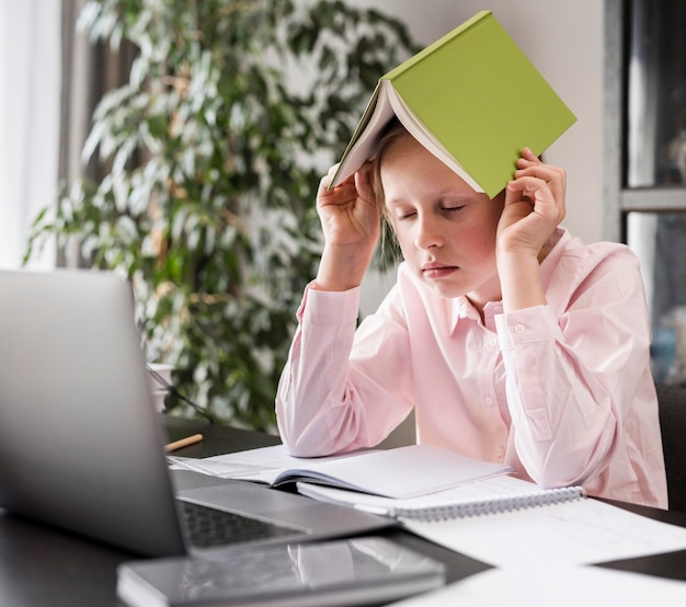 Girl putting a book on her head