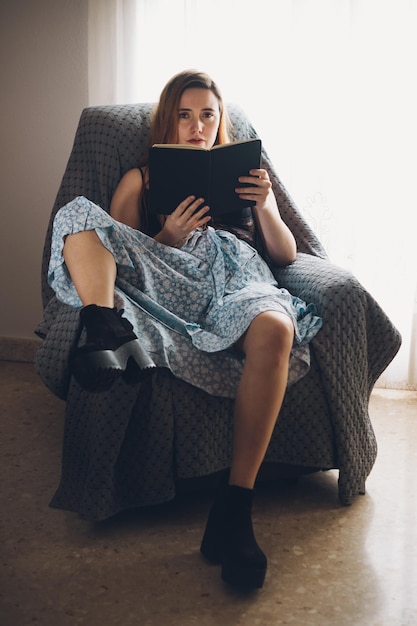 Girl reading a book in a couch