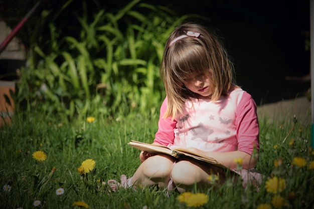 girl reading book in garden