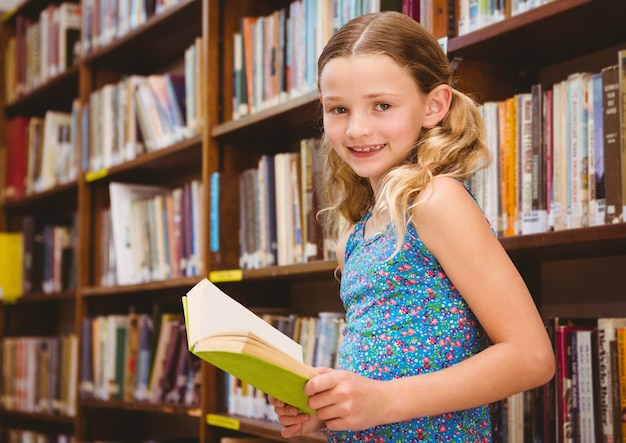 Girl reading book in library