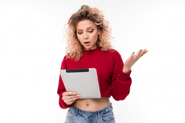 girl reads messages on tablet on white