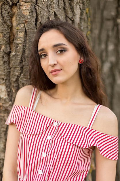 Girl in red dress on nature in summer Portrait of a beautiful girl in the summer in the forest