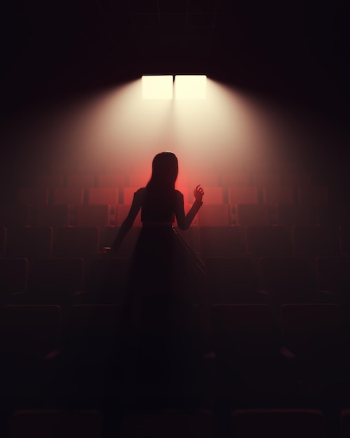A girl in a red dress sitting in a cinema theater