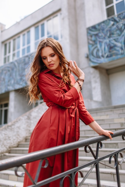 A girl in a red dress standing on the stairs