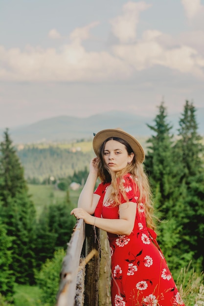 A girl in a red dress on a walk in a mountainous area