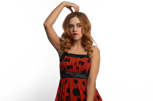 A girl in a red dress on a white background.fun and emotions.