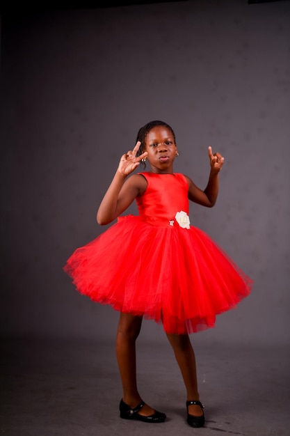 A girl in a red dress with the number 2 on it