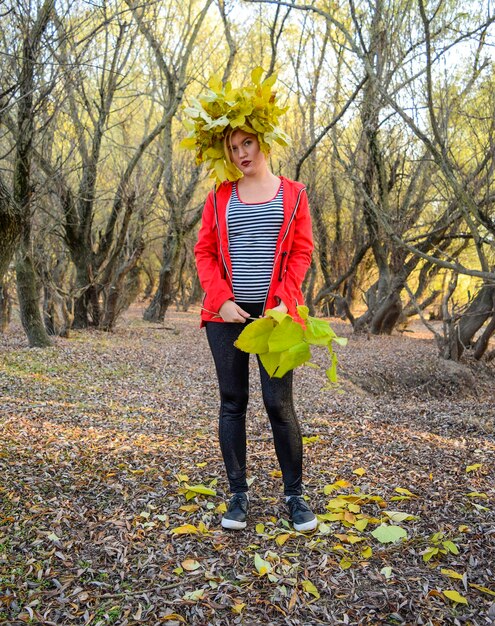 Girl in a red jacket with a wreath of yellow autumn leaves The Queen of Autumn Miss autumn Autumn Walk