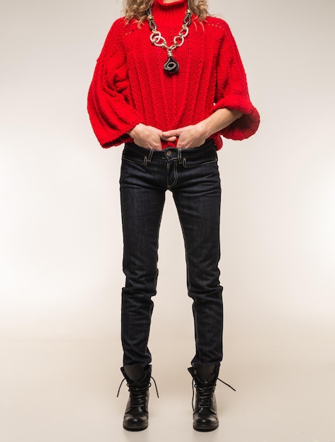 girl in a red sweater posing on a white background