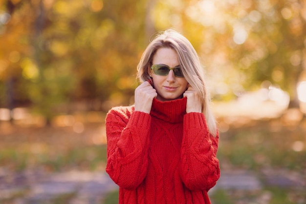 a girl in a red sweater walks in the autumn in the park the concept of the autumn season