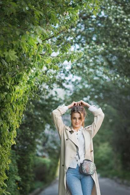 A girl rejoicing in the spring is spinning in a tunnel of green bushes 2984